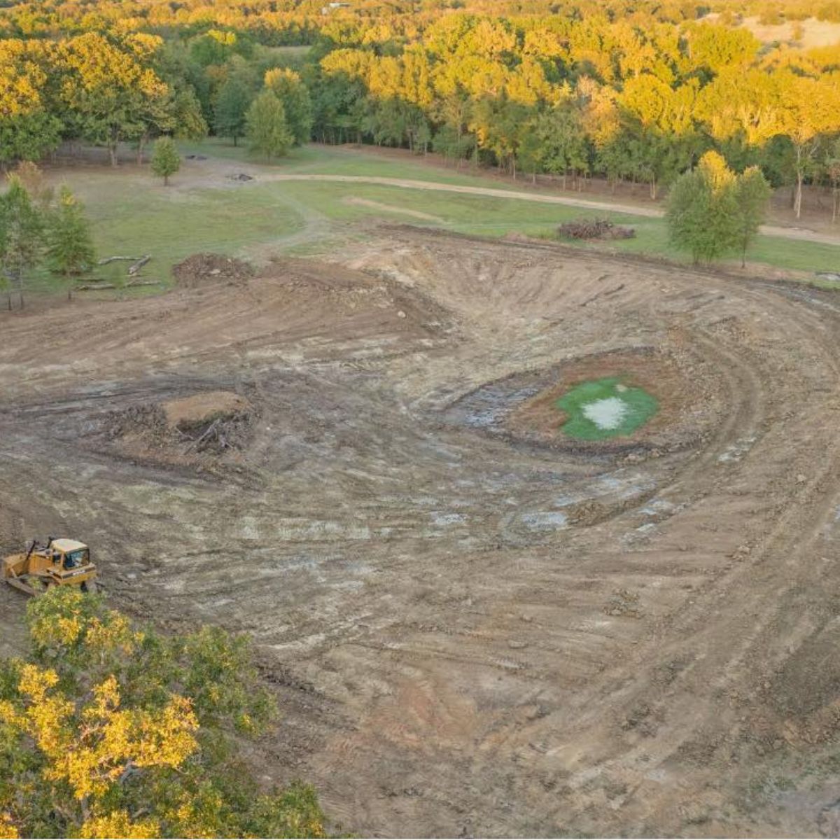aerial photo showing bulldozer next to completed lake expansion in Paris, Texas
